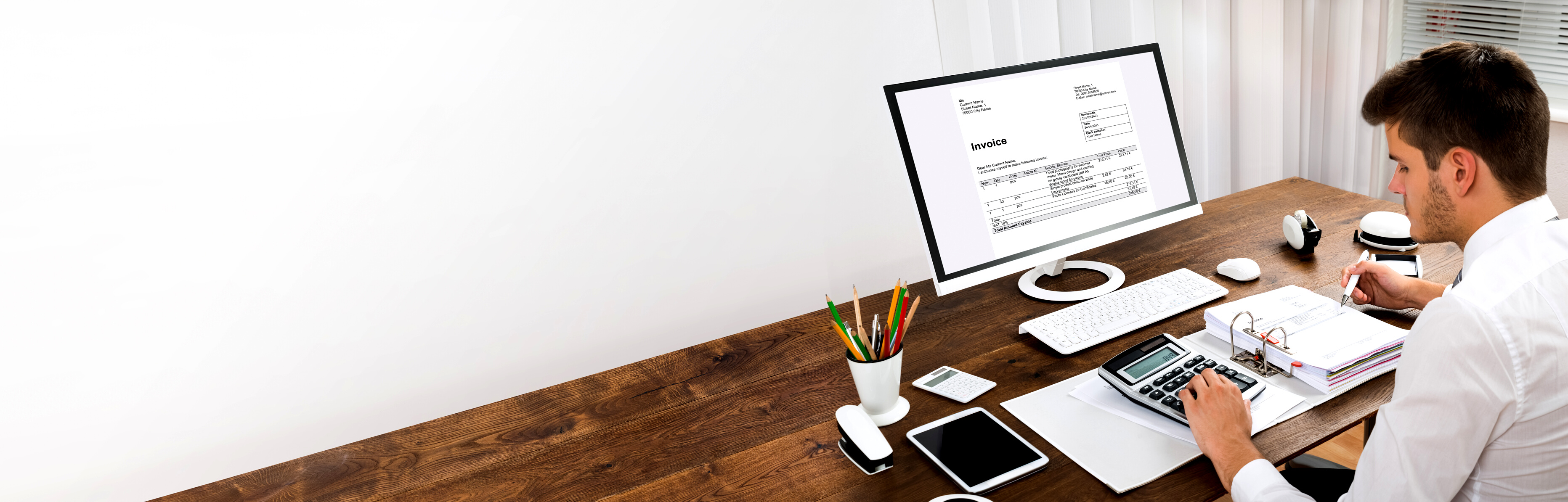 Accountant Calculating Tax At Desk